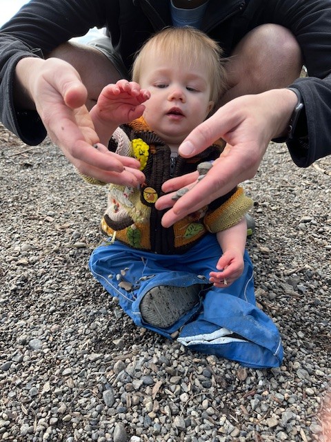 baby touching stones